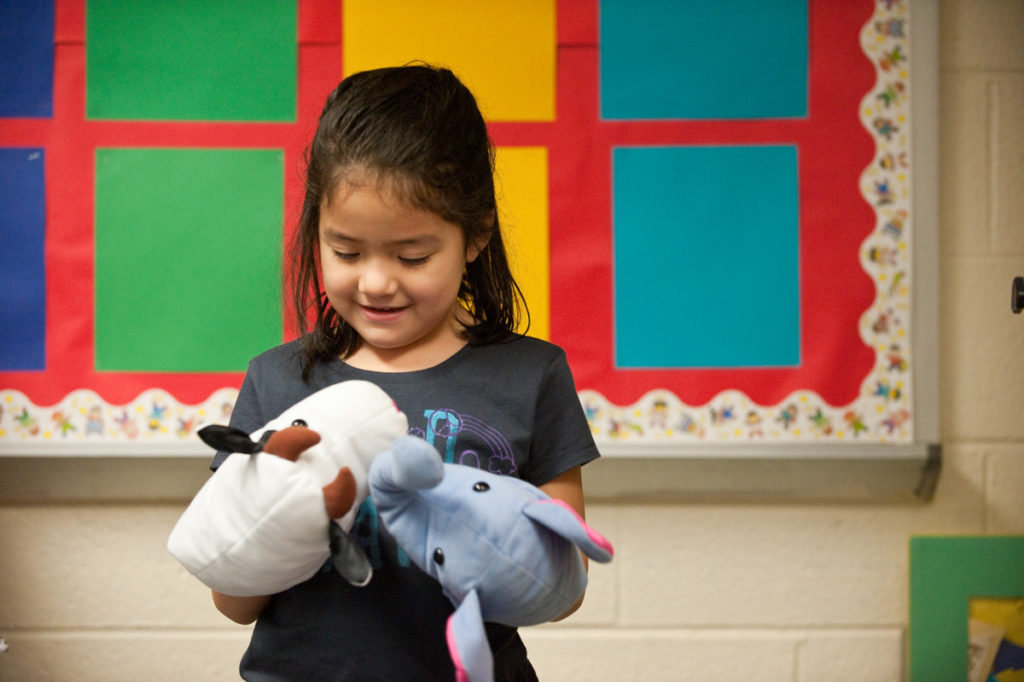 girl with puppets, photograph by Jeff Woodward.
