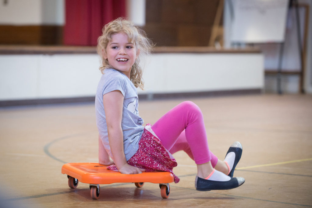 girl on wheeled cart. hotograph by Jeff Woodward.