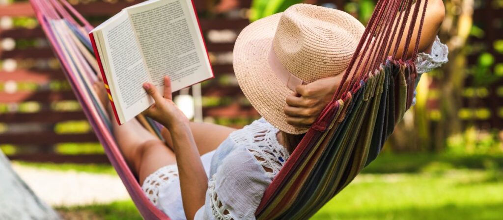 woman in a hammock reading a book