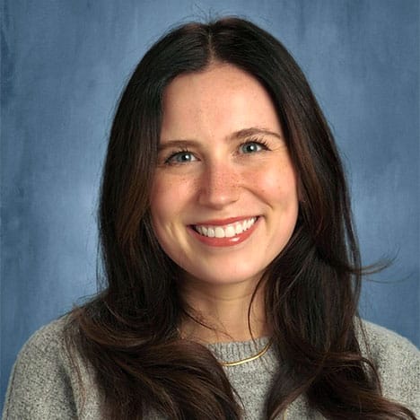 Responsive Classroom teacher, Alana Espinoza, smiling against a blue background.