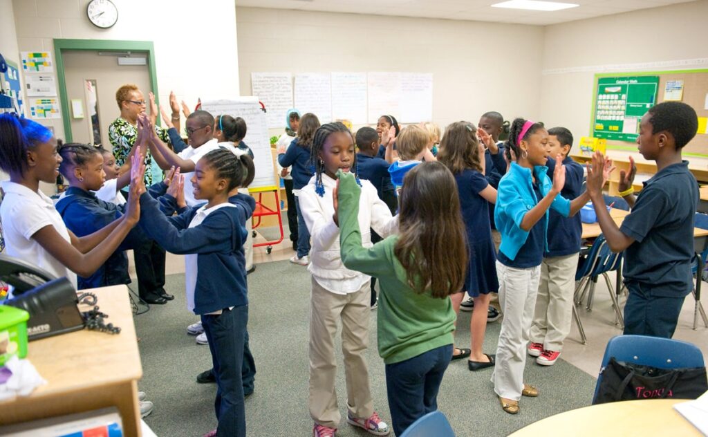 Students interacting and moving during an energizer activity