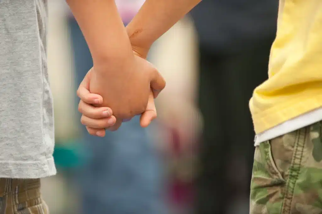 students hold hands